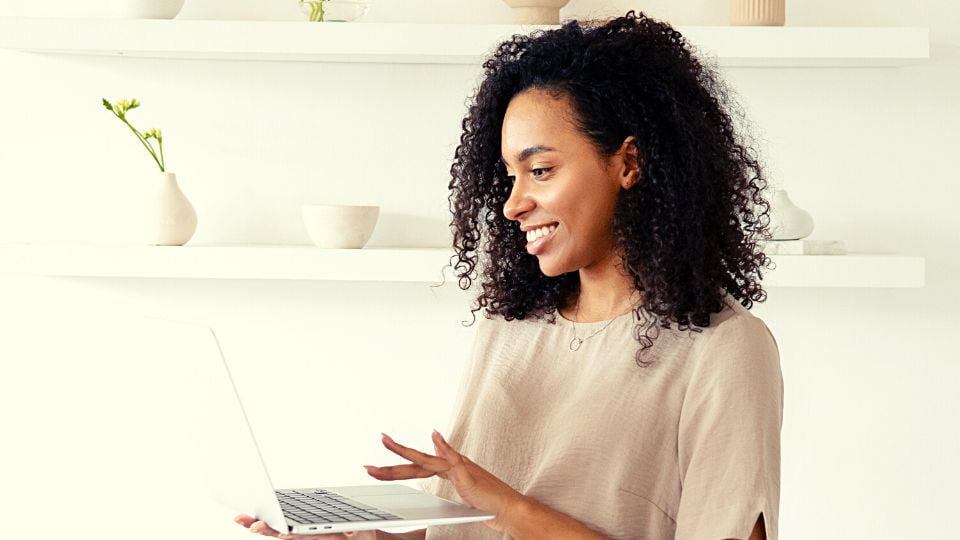 Photo of a black woman browsing a laptop. Featured Image for All Highly Sensitive Person Resources Page